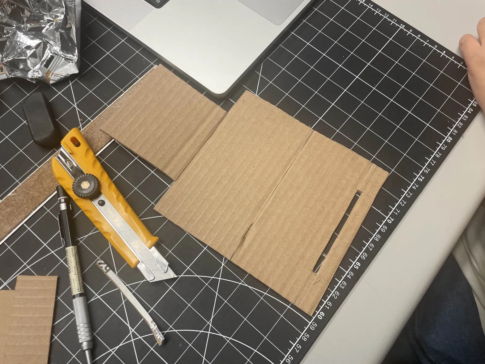 The 'geometry net' of the phone stand laid flat before assembling it